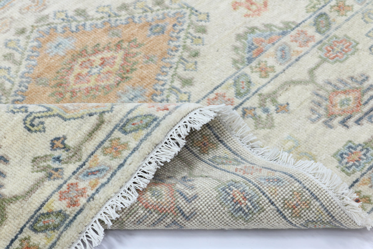 Close-up of a patterned rug with a white border