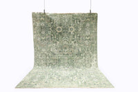 Green patterned rug on a white background
