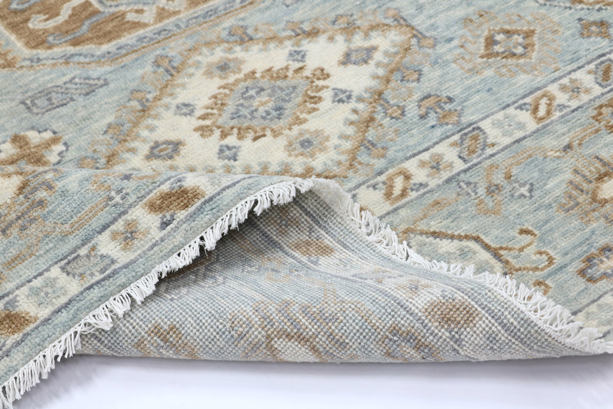 Close-up of a patterned rug with fringed edge on a white background