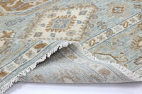 Close-up of a patterned rug with fringed edge on a white background