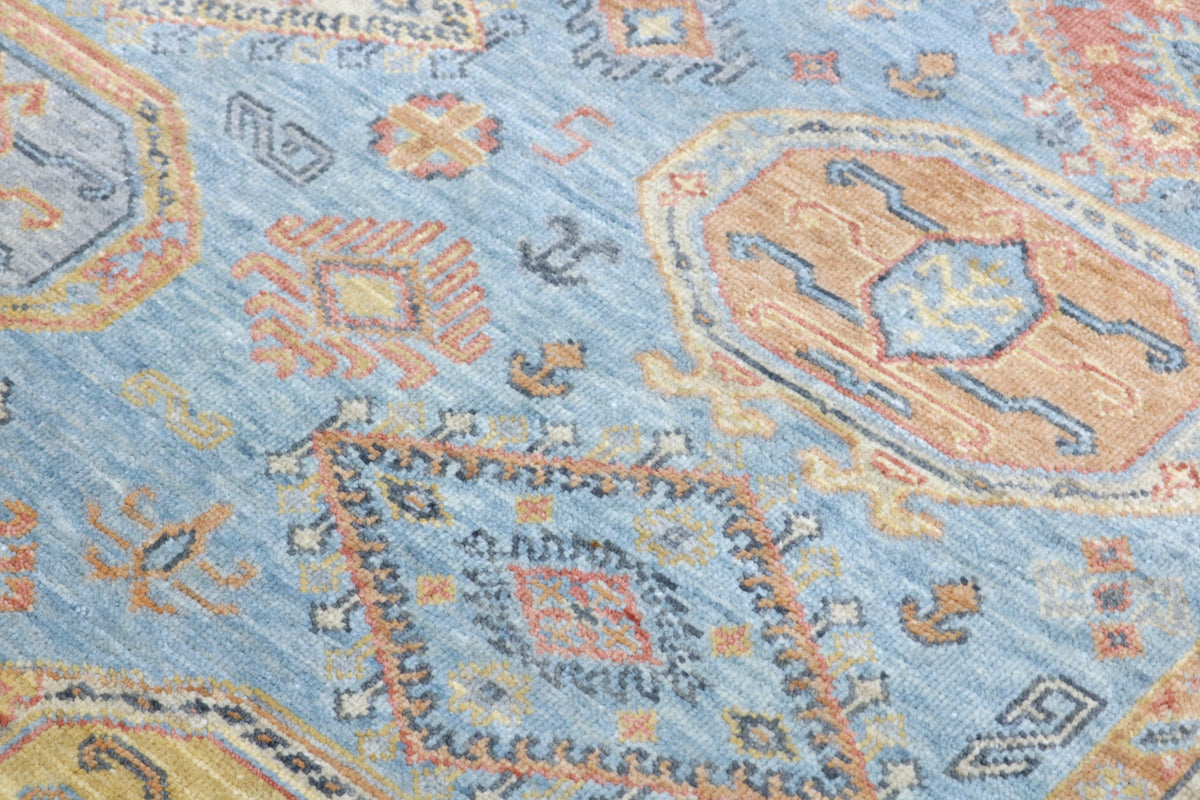 Close-up of a patterned rug with blue and orange colors
