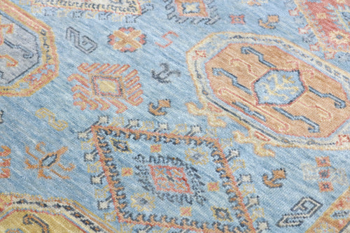 Close-up of a patterned rug with blue and orange colors