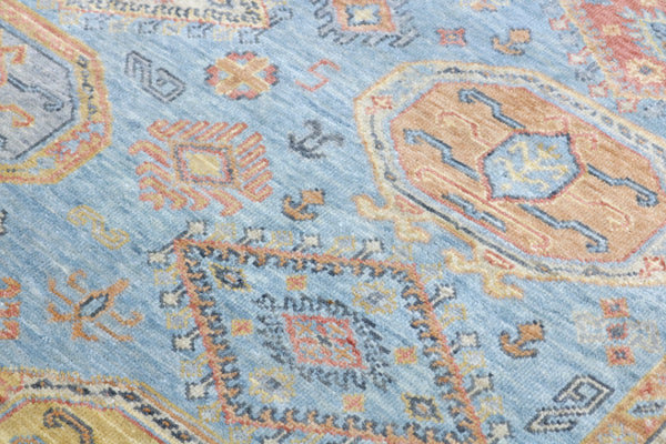 Close-up of a patterned rug with blue and orange colors