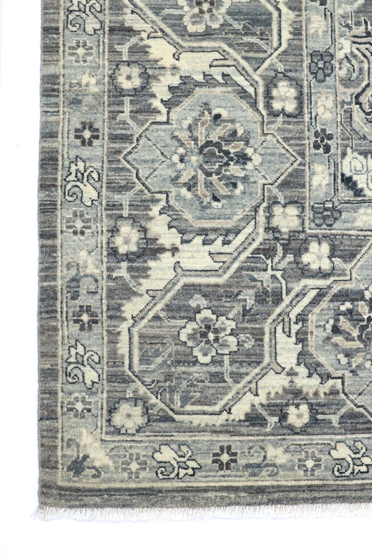 Close-up of a patterned rug with geometric designs and floral elements.