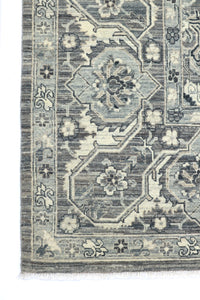 Close-up of a patterned rug with geometric designs and floral elements.