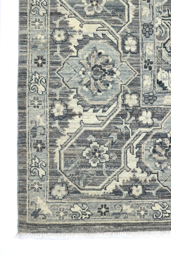 Close-up of a patterned rug with geometric designs and floral elements.