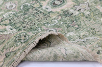 Close-up of a green patterned rug with a textured surface.
